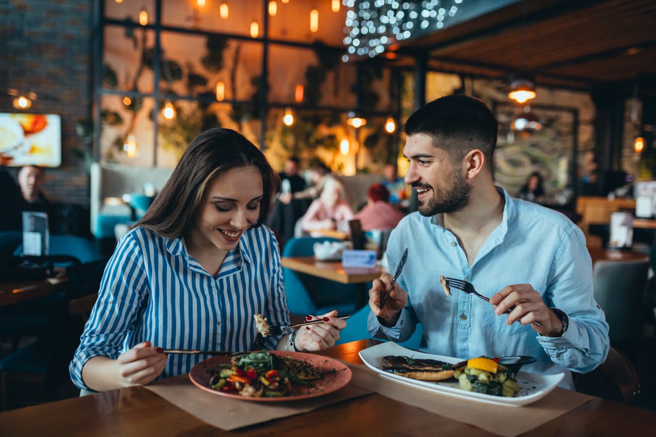 Couple enjoying dinner in a warmly lit restaurant
