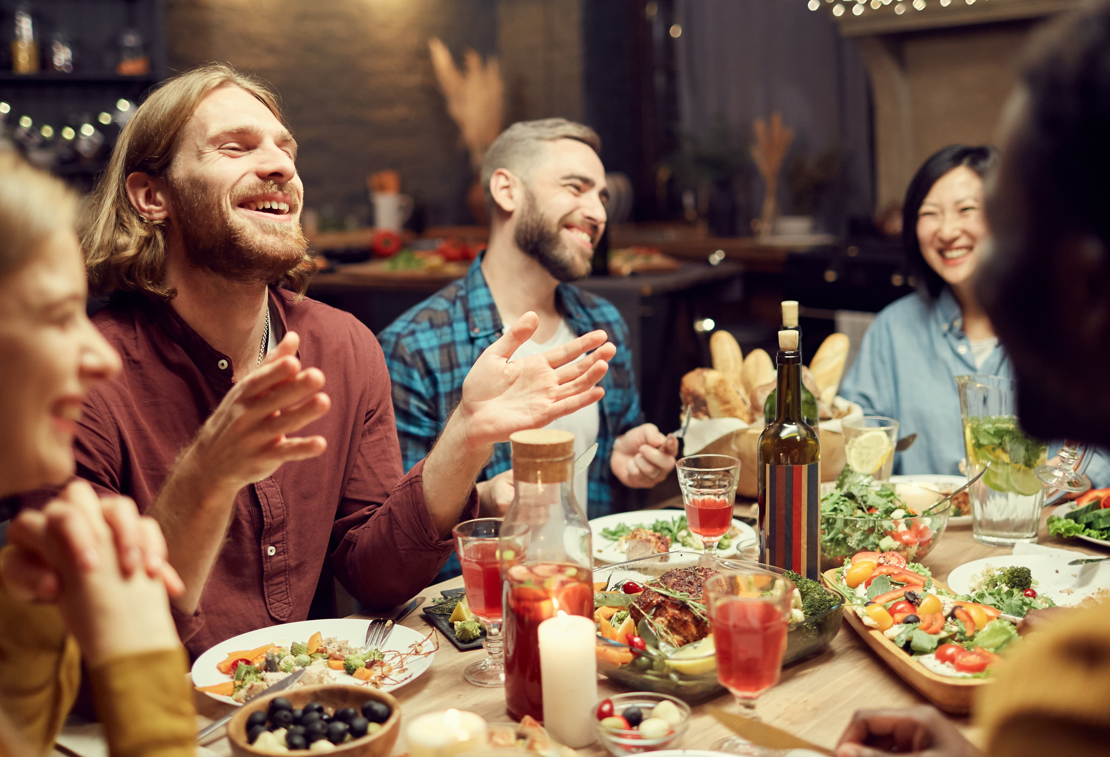 Friends laughing together over a meal in a welcoming restaurant
